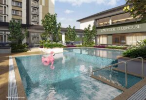 Outdoor pool at Daffodil Residency Puncak Alam Clubhouse with a pink flamingo float and lush greenery around a modern residential complex
